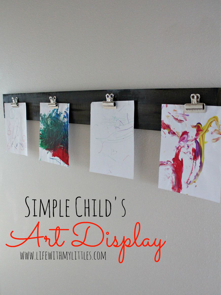 This cheap and easy way to display your child's artwork is made with a wood board and clips! It's super simple, but looks expensive!