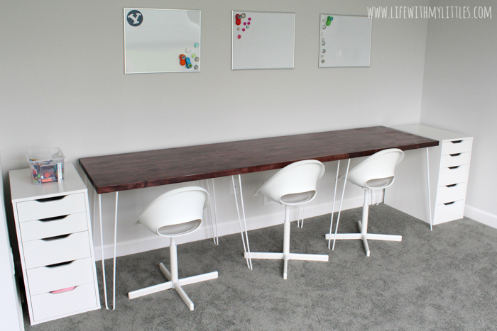 A simple, minimalist DIY triple desk tutorial that even the most beginning of DIYers can tackle! The butcher block countertop gives it a beautiful farmhouse feel and it's perfect for any homework or homeschool room!