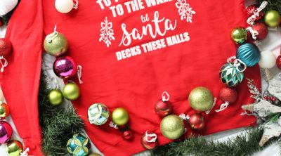 "To the Window, to the Wall, 'Til Santa Decks these Halls" Christmas parody sweatshirt that you can DIY! All you need is a Cricut, vinyl, screen printing supplies, and a sweatshirt to make this hilarious holiday sweater.